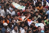 Palestinians carry bodies of killed Hamas commanders