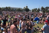 Thousands of people party on St Kilda beach on Christmas day.