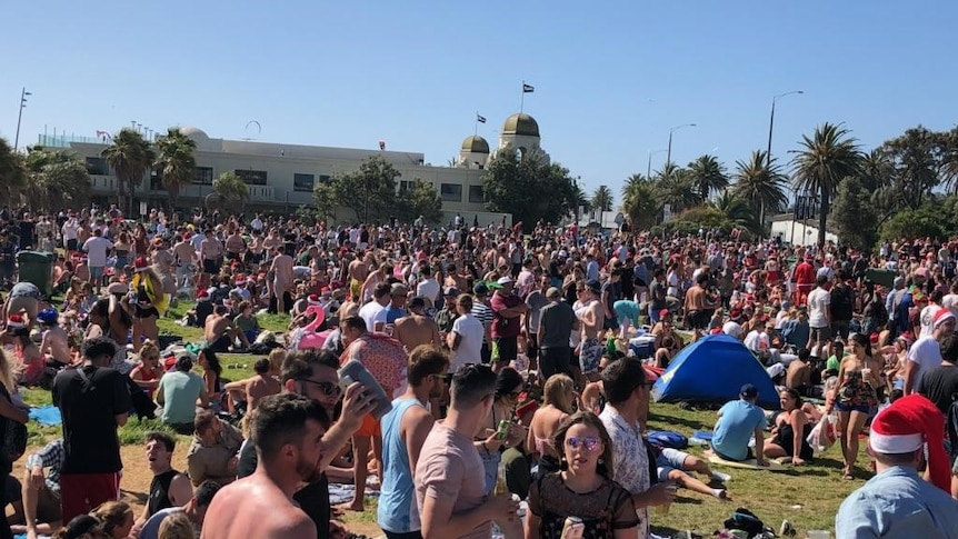 Thousands of people party on St Kilda beach on Christmas day.