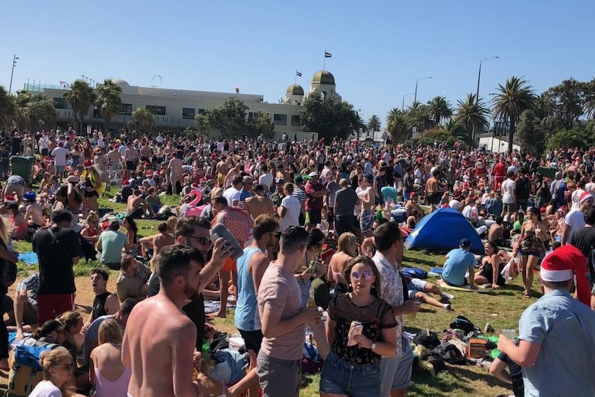 Thousands of people party on St Kilda beach on Christmas day.