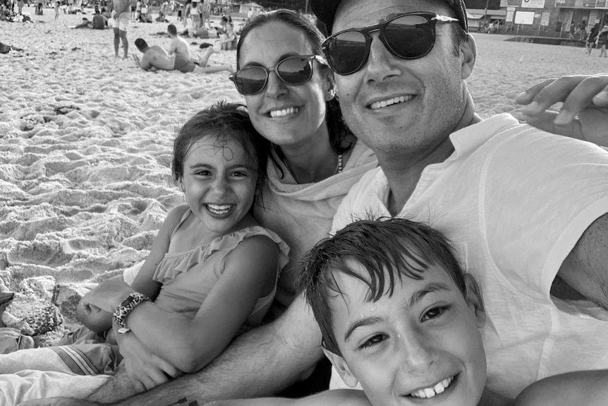 Black and white pic of family on the beach 