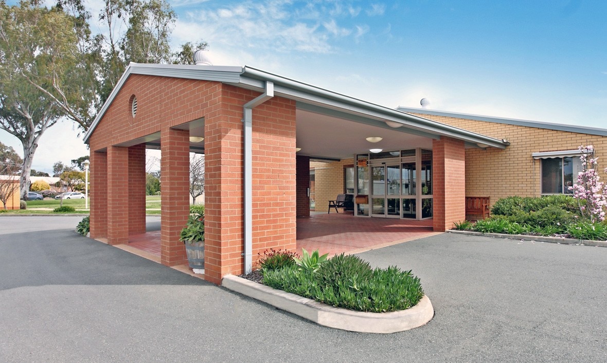 An aged care facility entrance with a red brick facade
