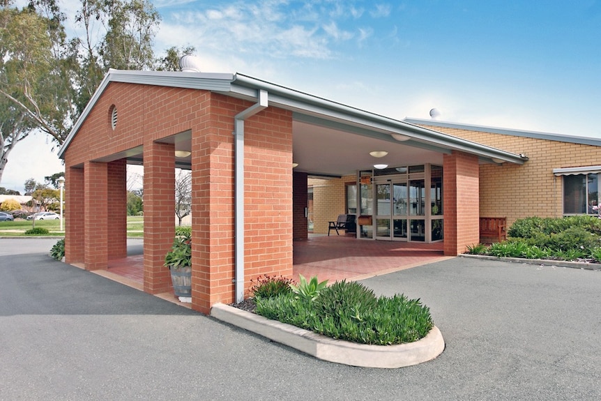 An aged care facility entrance with a red brick facade