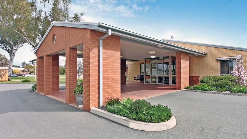 An aged care facility entrance with a red brick facade.