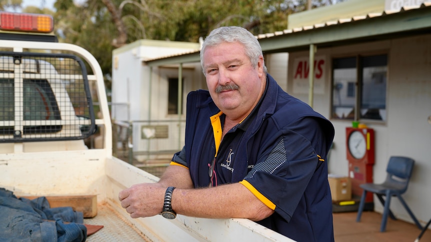 Leinster shire president Peter Craig leaning on the back of a ute and looking into the camera.
