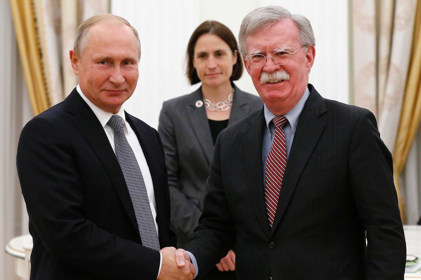 Vladimir Putin and John Bolton shake hands during their meeting in the Kremlin in Moscow.
