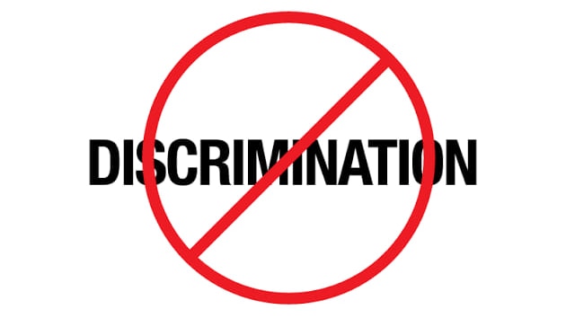 The word discrimination written in black text on a white background, with a large red circle and a cross.