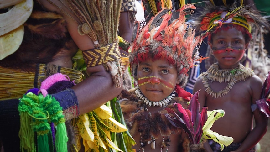 Papua New Guinea children with painted faces and head dress at election rally