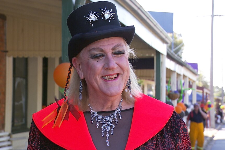 A transgender woman is dressed up for a Halloween street party.