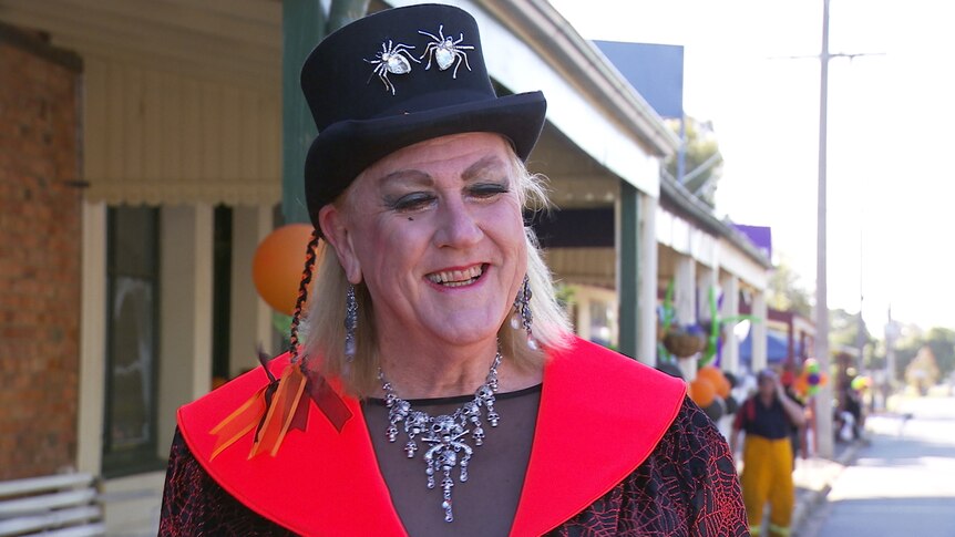 A transgender woman is dressed up for a Halloween street party.