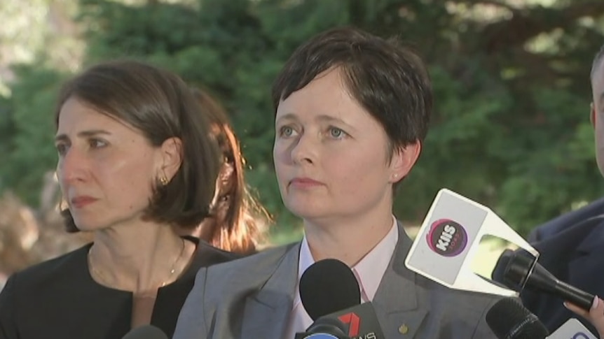 Two women speak to media.