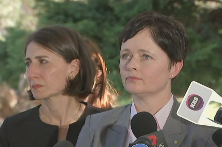 Two women speak to media.