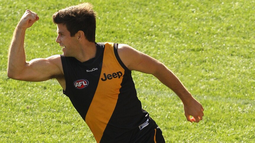 Triumph in Tigertown ... three goals from Trent Cotchin help guide Richmond to its first win