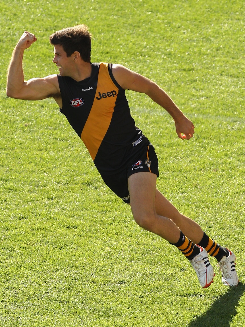 Triumph in Tigertown ... three goals from Trent Cotchin help guide Richmond to its first win