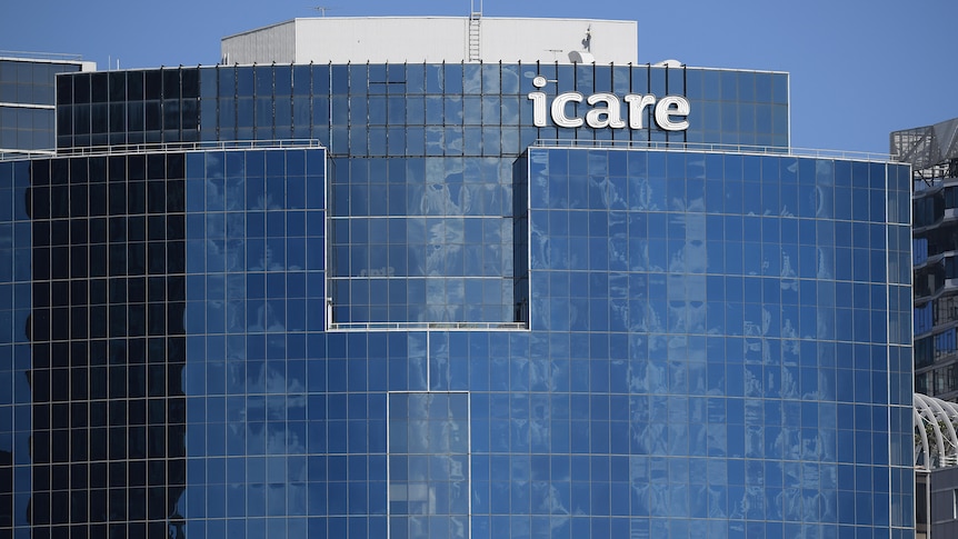 a big building with glass panels and letters across the top