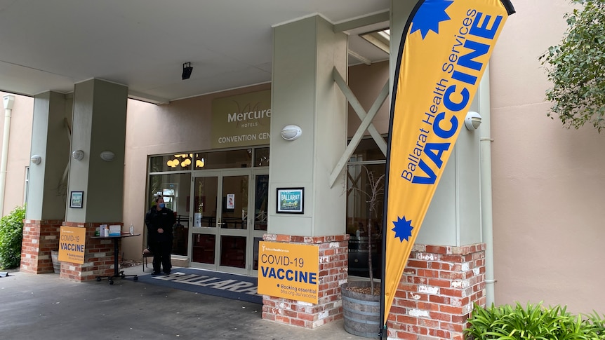 A hotel with vaccine flags outside