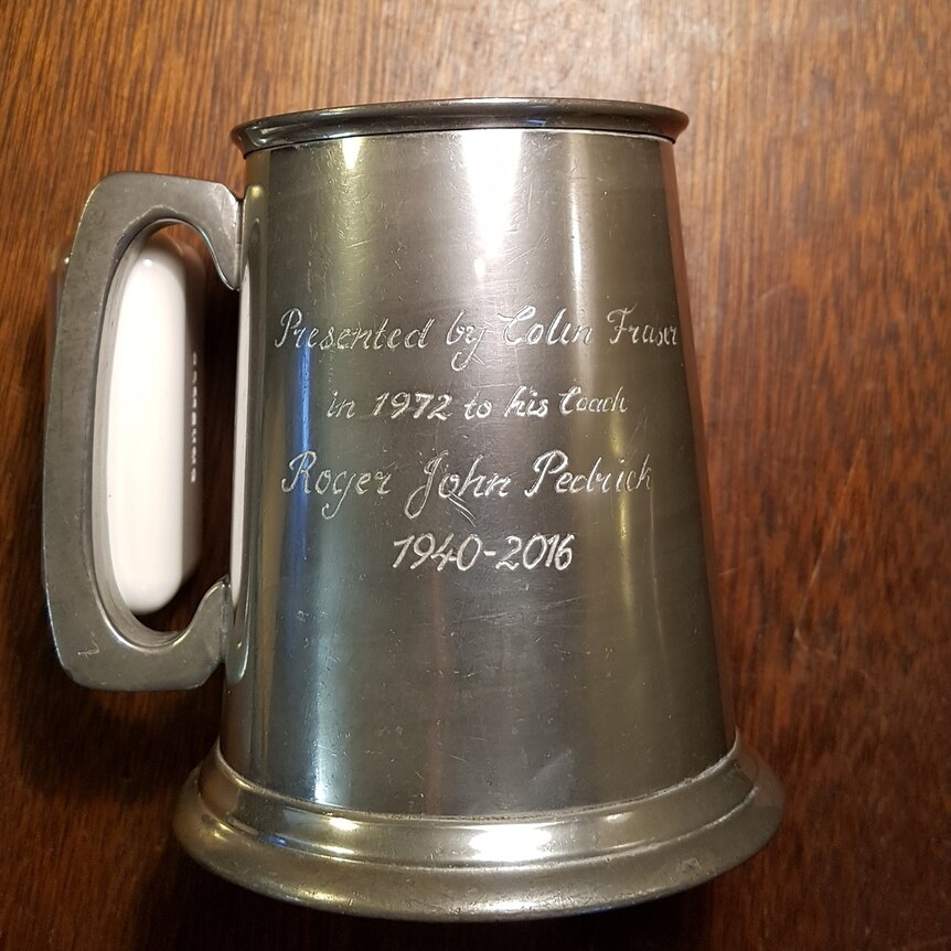 A pewter mug inscribed with the winners name