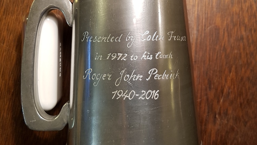 A pewter mug inscribed with the winners name