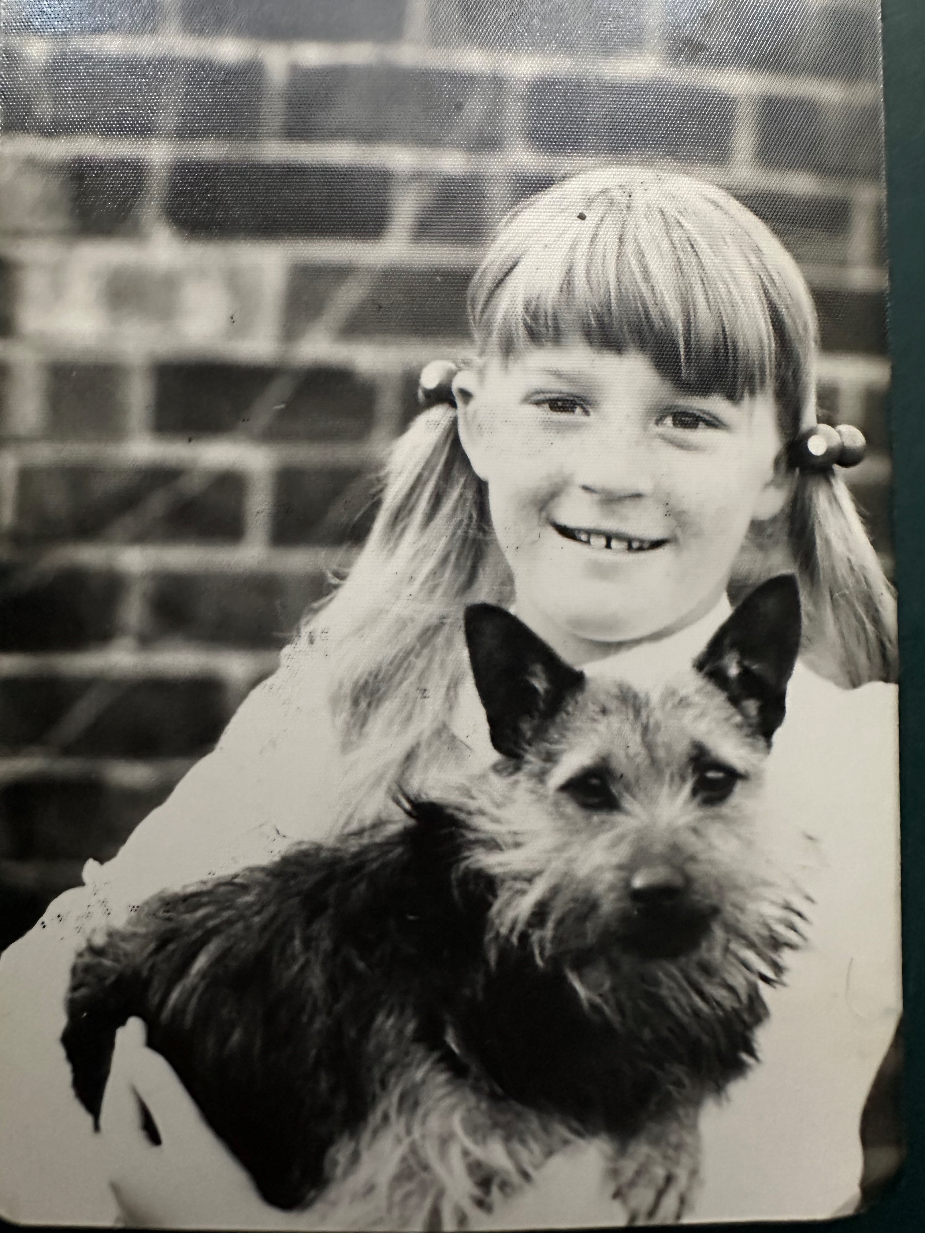 black and white photo of Andrea aged about 9 with dog 