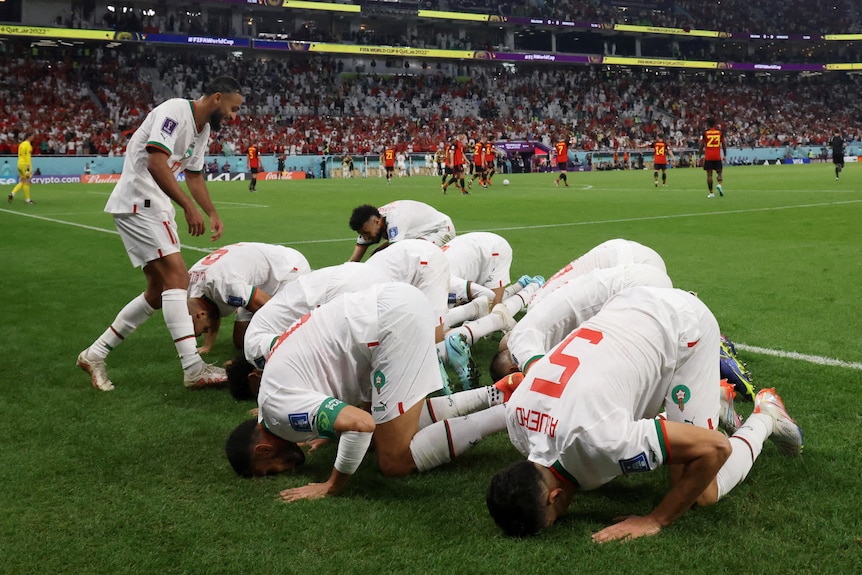 Morocco footballers kiss the turf in Qatar.