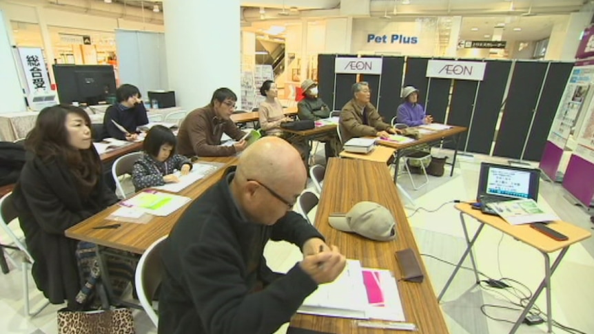 Japanese people attend a funeral planning seminar