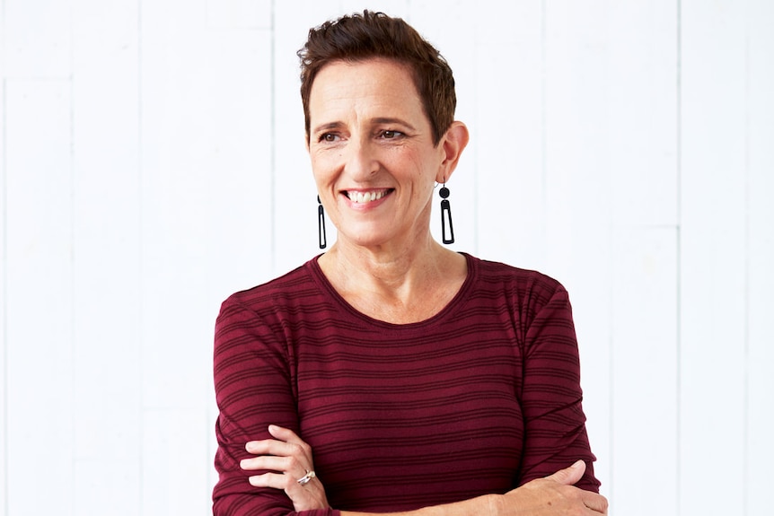 A headshot of the author with her arms folded.