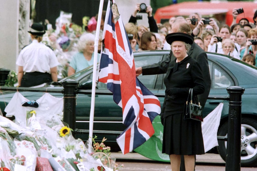 Queen and the Duke of Edinburgh look at floral tributes laid outside Buckingham Palace in memory of Princess Diana.