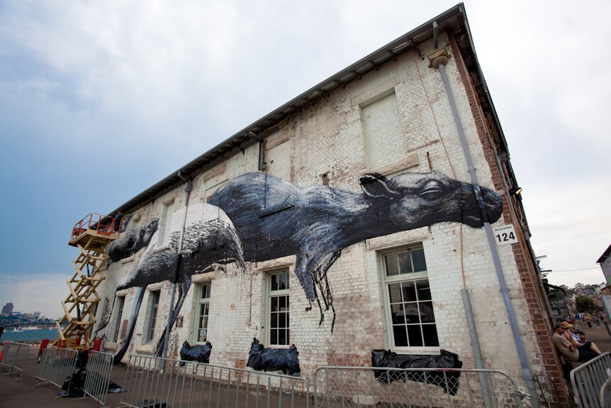 A work by street artist Roa adorn a wall on Sydney's Cockatoo Island as part of the Outpost street art festival.