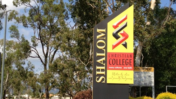 A colourful front sign outside leafy Shalom Christian College in Townsville.