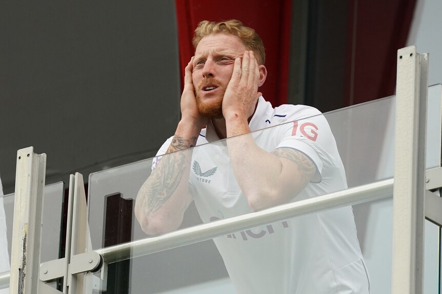 Ben Stokes looks out from the balcony with his head in his hands