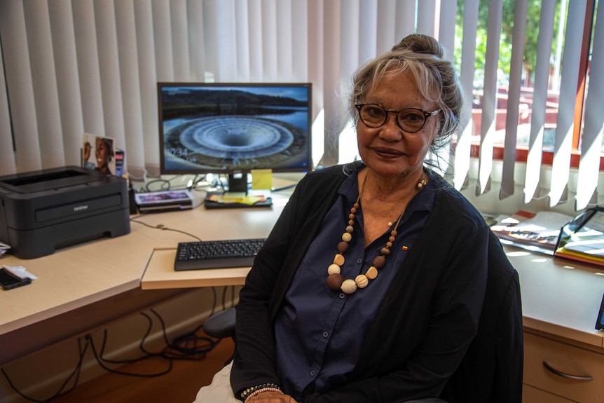 Barb Shaw sitting in front of a computer in office