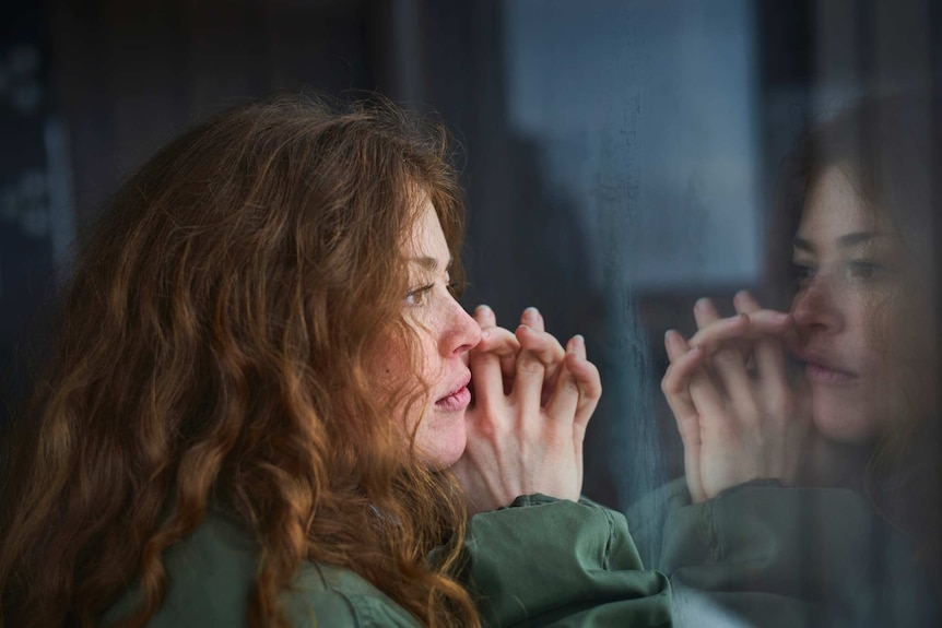 Woman looking out of window