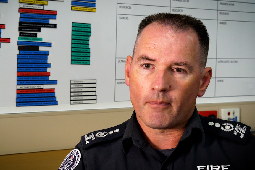 Fire Officer with short hair sitting in uniform