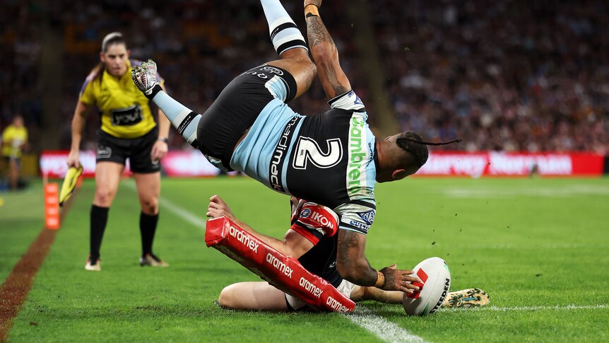 Cronulla Sharks winger Sione Katoa dives in to score a try against the Sydney Roosters.