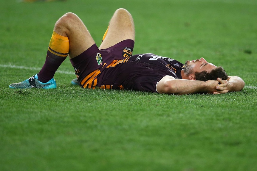 Brisbane half-back Hunt lies on the ground during the NRL grand final