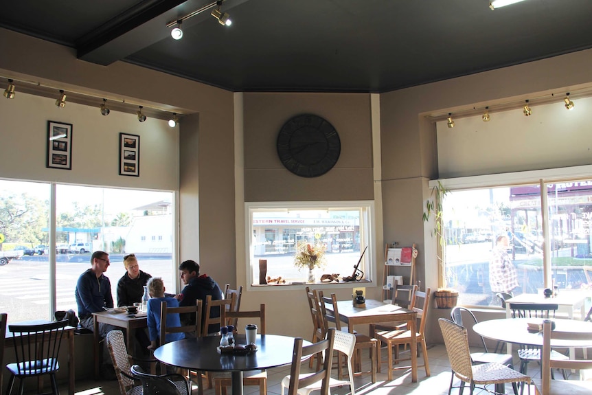 A wide shot of the inside of a country cafe.