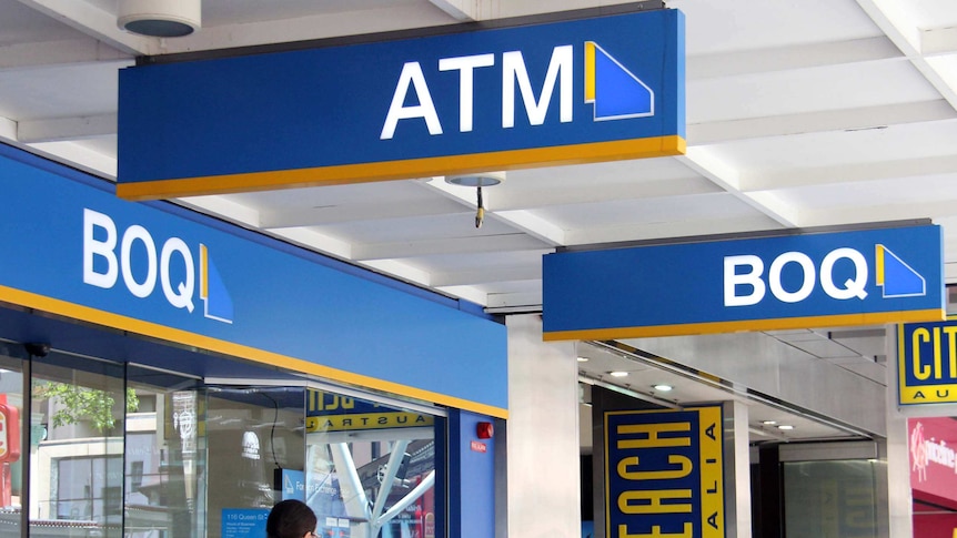 People walking past a Bank of Queensland branch in Brisbane.