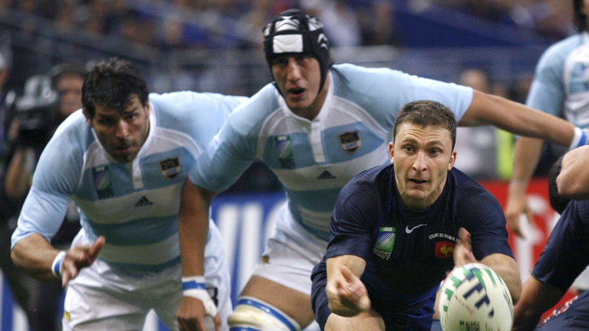 Pounced on: Pierre Mignoni of France gets the ball away as the Pumas close in (File photo)