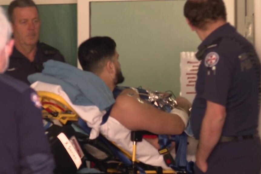man on a stretcher at hospital