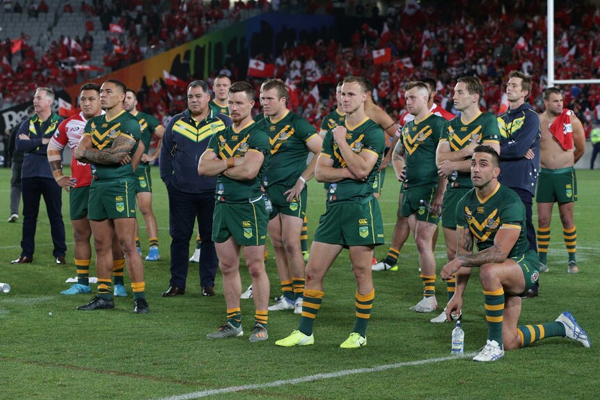 Australian rugby league players look on dejected after losing to Tonga.
