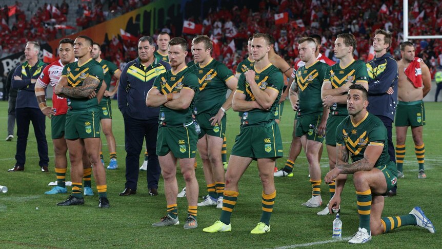 Australian rugby league players look on dejected after losing to Tonga.