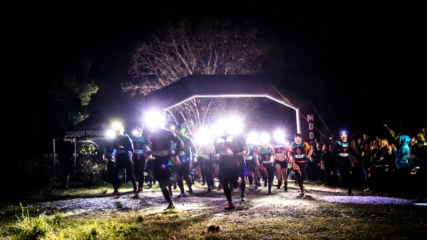 Runners at night with head lamps on.