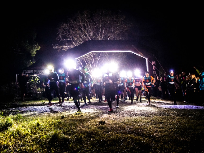 Runners at night with head lamps on.