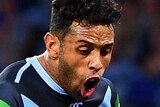 Josh Addo-Carr jumps over a huddle of New South Wales Blues players as Dylan Napa stands in the foreground.