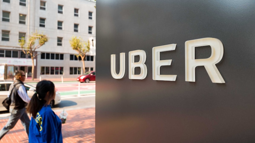 A large Uber logo on a building.