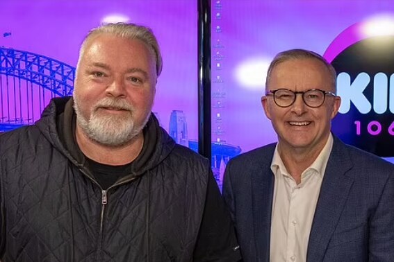 Sandilands and Albanese pose together in the KIIS FM studio.