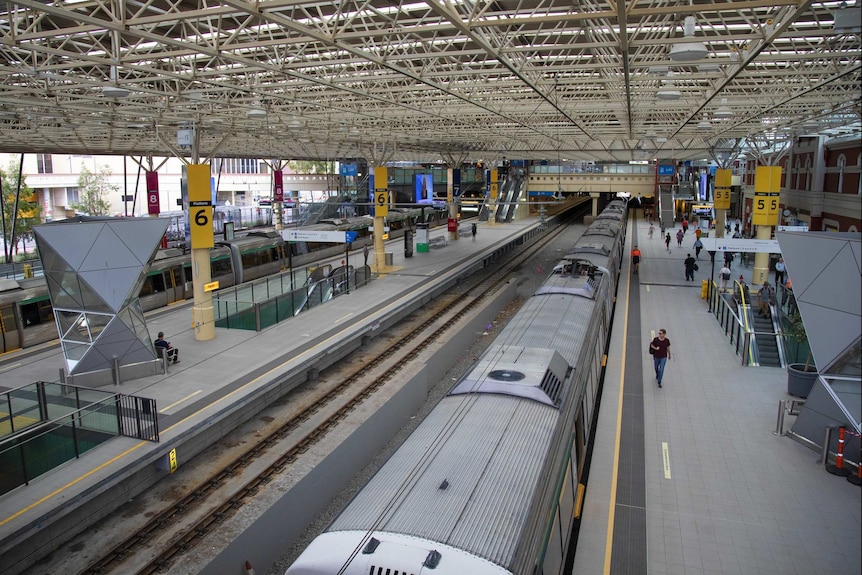 A wide shot of an almost empty train station