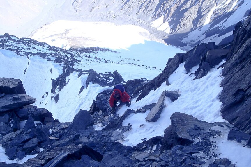 A climber navigates a slope on Noshaq