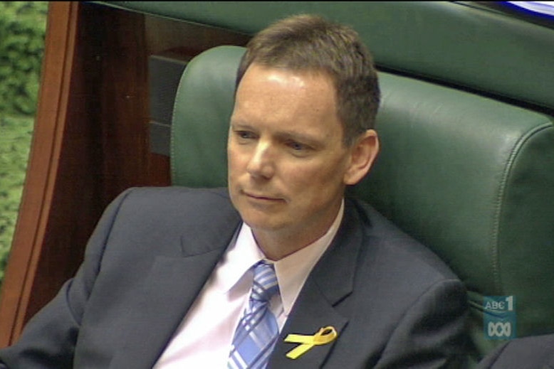 A man sitting in parliament.
