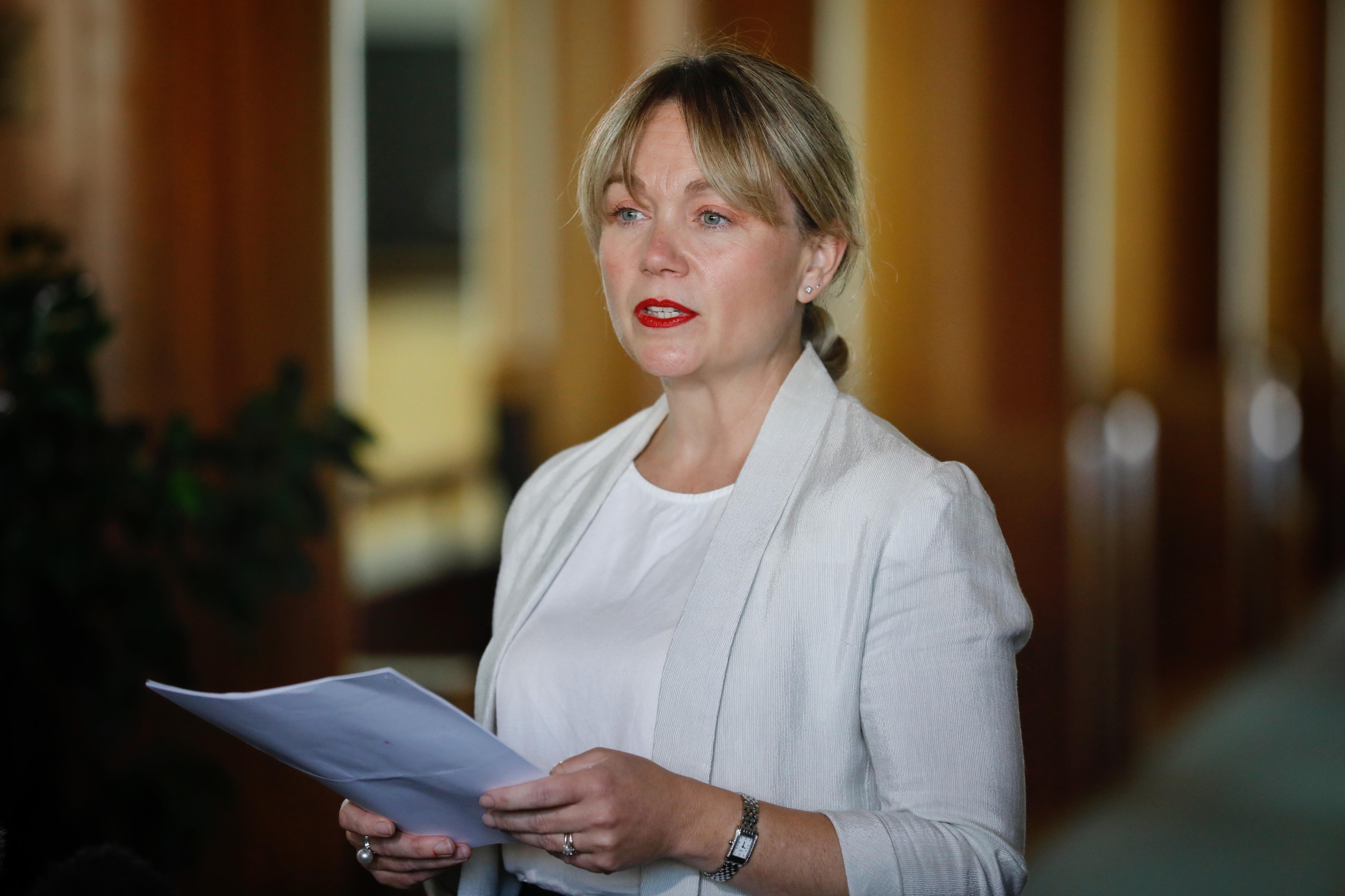 Rachelle Miller reads from a piece of paper 